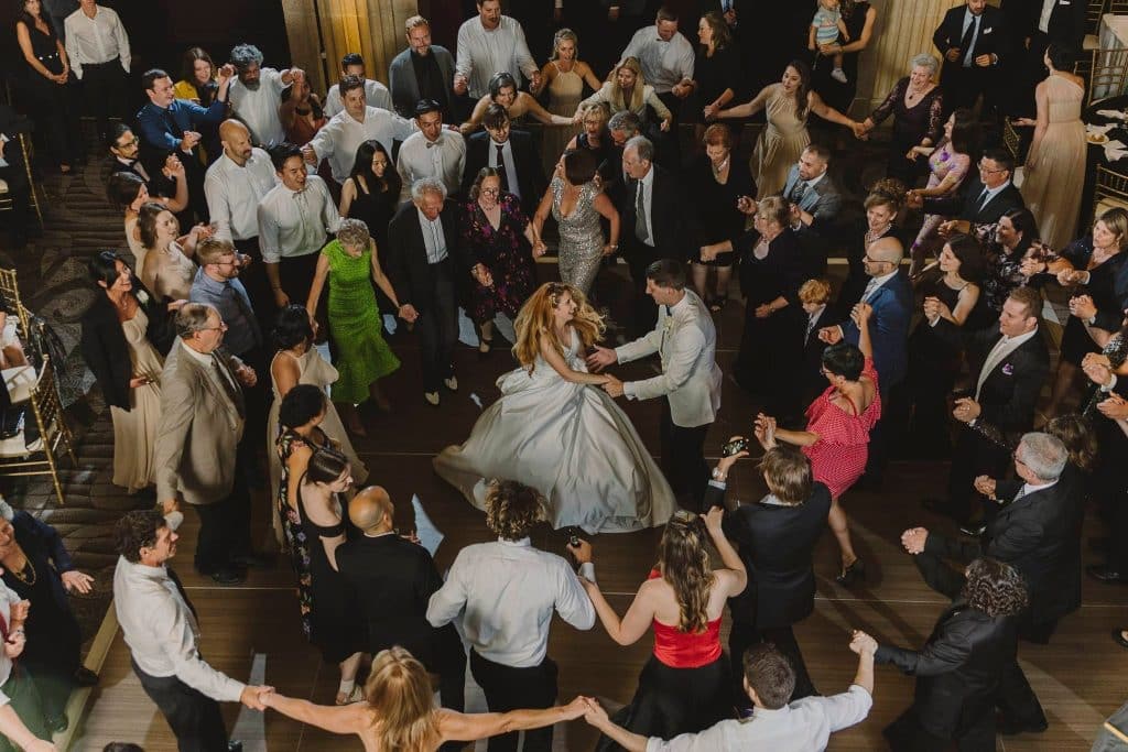 Wedding guests in a circle dance on the floor