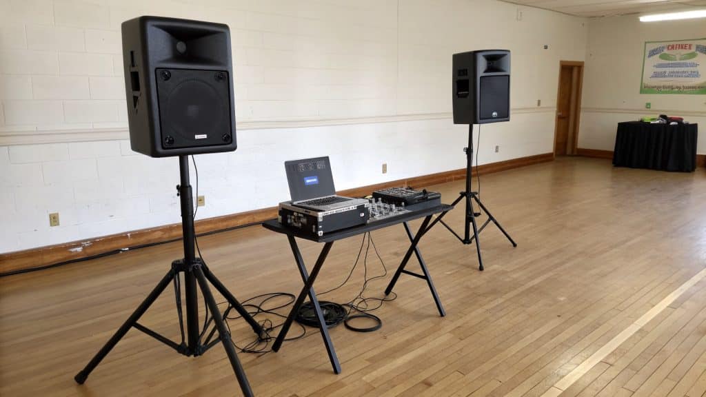 A basic DJ setup with a controller and two speakers