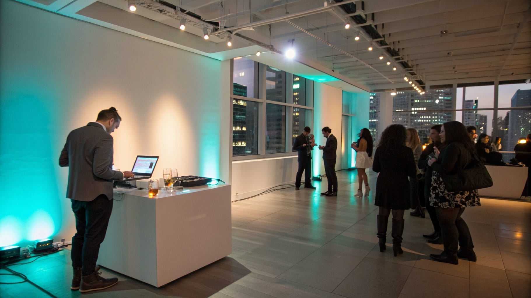 DJ booth with uplighting at a corporate event in a Toronto showroom